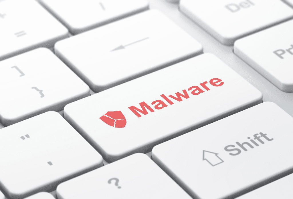 Close-up of a computer keyboard key labeled “Malware,” highlighting malicious software threats, common malware infection signs, and the importance of malware prevention for businesses.